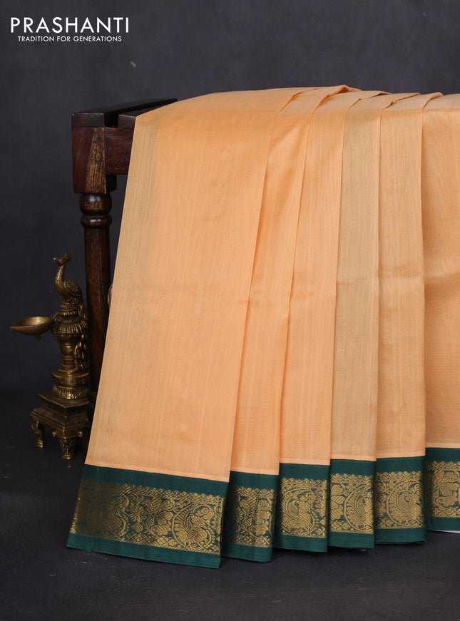 Silk cotton saree pale orange and green with plain body and zari woven korvai border