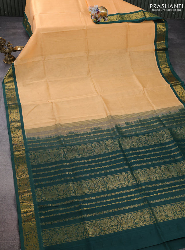 Silk cotton saree pale orange and green with plain body and zari woven korvai border