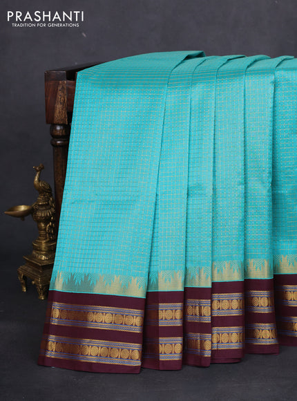 Silk cotton saree teal blue and brown with allover small zari checked pattern and temple design zari woven korvai border
