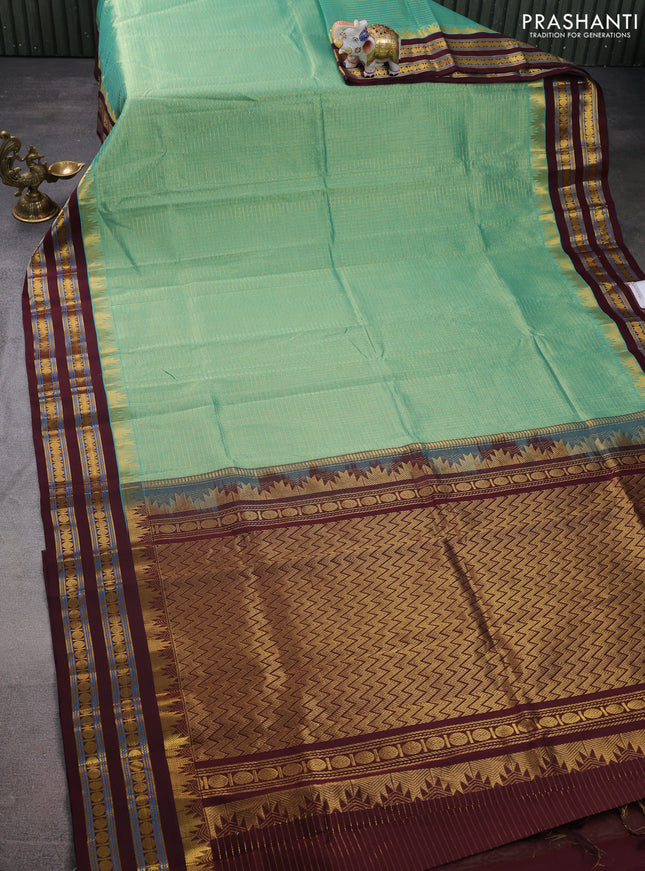 Silk cotton saree pastel green and deep maroon with allover small zari checked pattern and temple design zari woven korvai border
