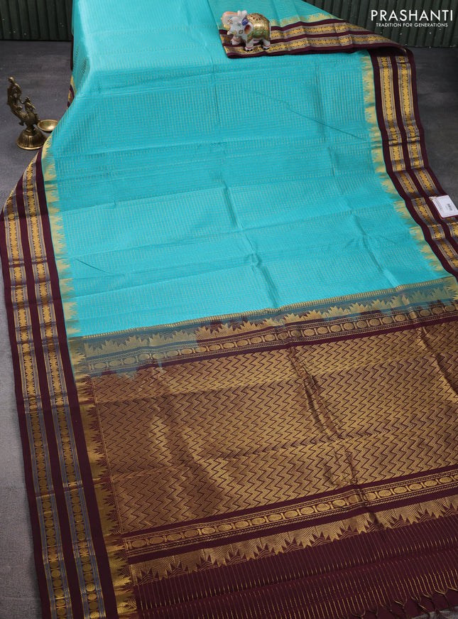 Silk cotton saree teal blue and deep maroon with allover small zari checked pattern and temple design zari woven korvai border