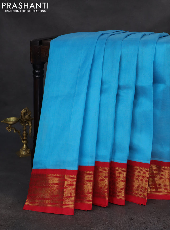 Silk cotton saree light blue and red with plain body and zari woven korvai border