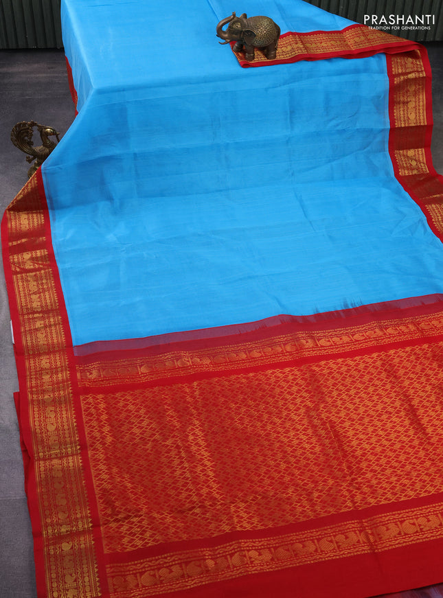 Silk cotton saree light blue and red with plain body and zari woven korvai border