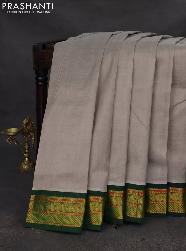 Silk cotton saree grey and green with plain body and zari woven korvai border