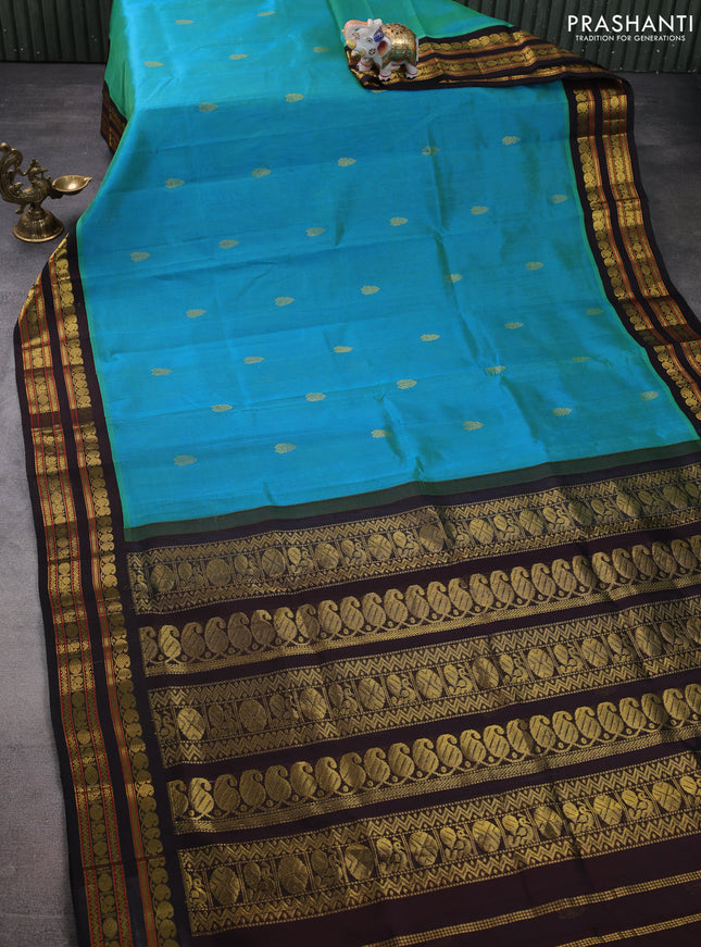 Silk cotton saree dual shade of teal bluish green and coffee brown with zari woven buttas and zari woven korvai border