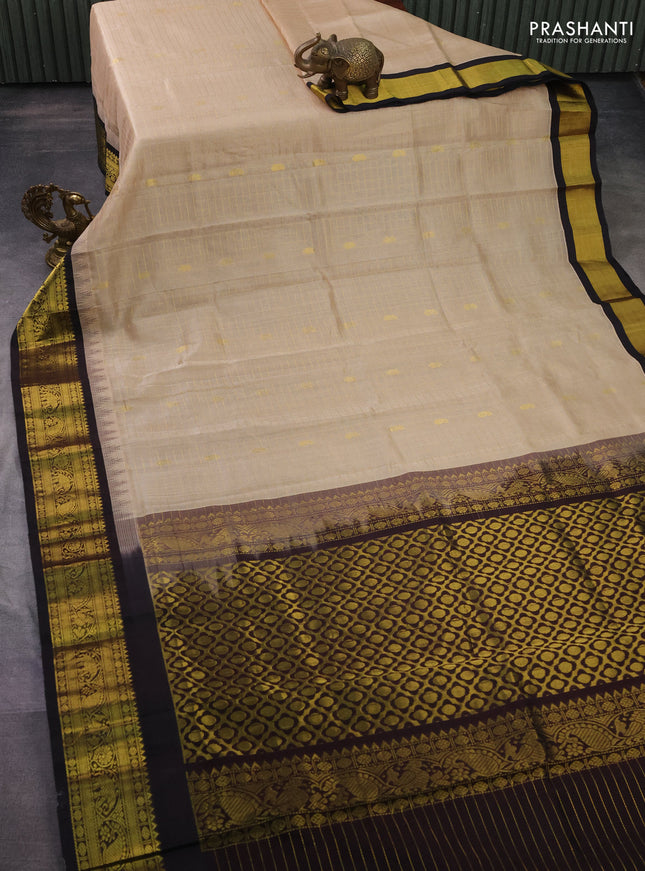 Silk cotton saree beifge and coffee brown with allover zari checks & buttas and temple design zari woven korvai border