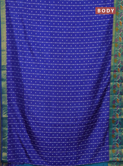 Semi tussar saree blue and teal green with allover ikat prints and zari woven ikat border