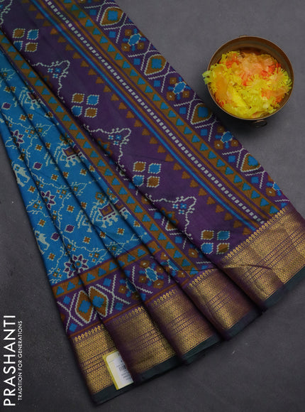 Semi tussar saree cs blue and purple with allover patola prints and zari woven border