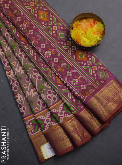 Semi tussar saree dual shade of grey and purple with allover patola prints and zari woven border