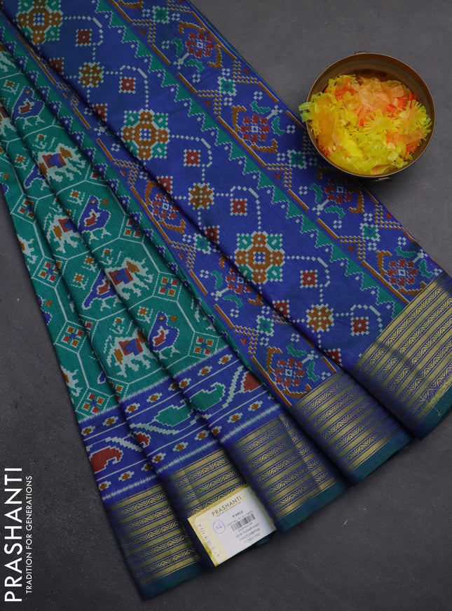Semi tussar saree teal green and blue with allover patola prints and zari woven border