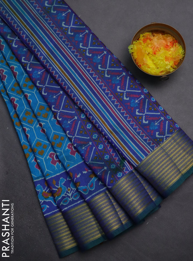 Semi tussar saree cs blue and blue with allover patola prints and zari woven border