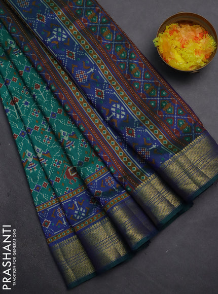 Semi tussar saree teal green and blue with allover patola prints and zari woven border