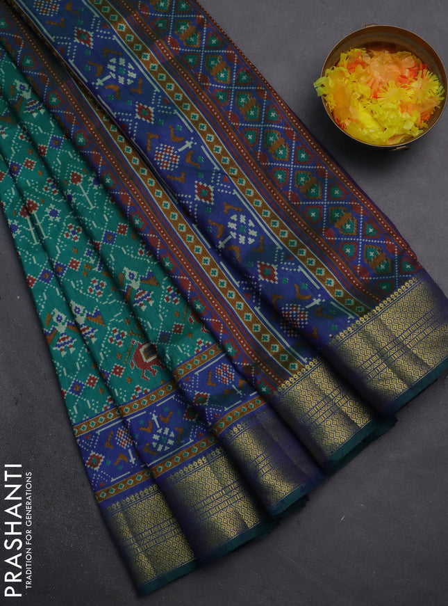 Semi tussar saree teal green and blue with allover patola prints and zari woven border