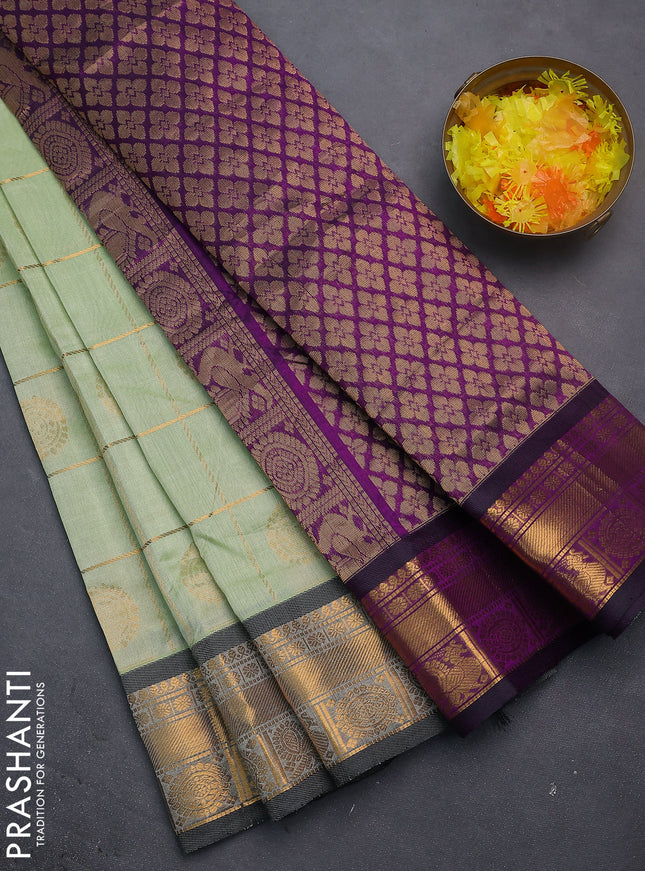 Silk cotton saree pista green and purple with allover zari checks & buttas and zari woven border
