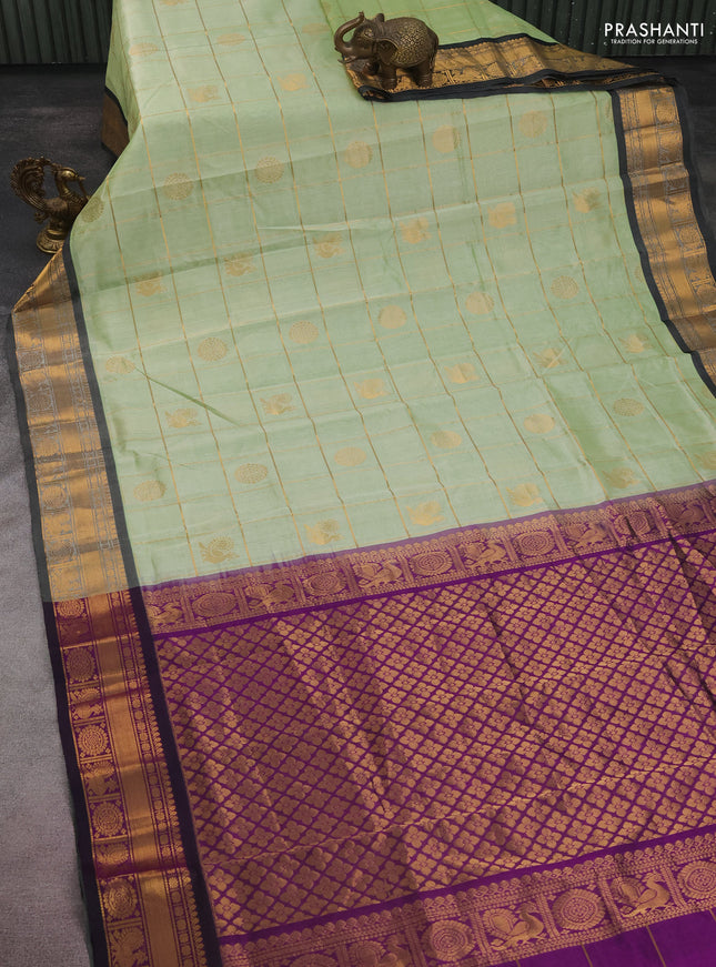 Silk cotton saree pista green and purple with allover zari checks & buttas and zari woven border