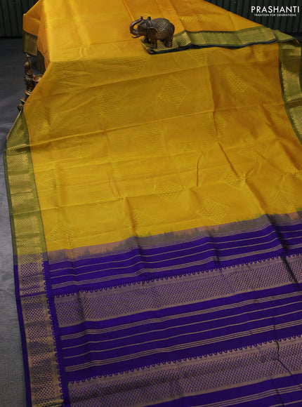 Silk cotton saree yellow and blue with allover self emboss jacquard and zari woven border