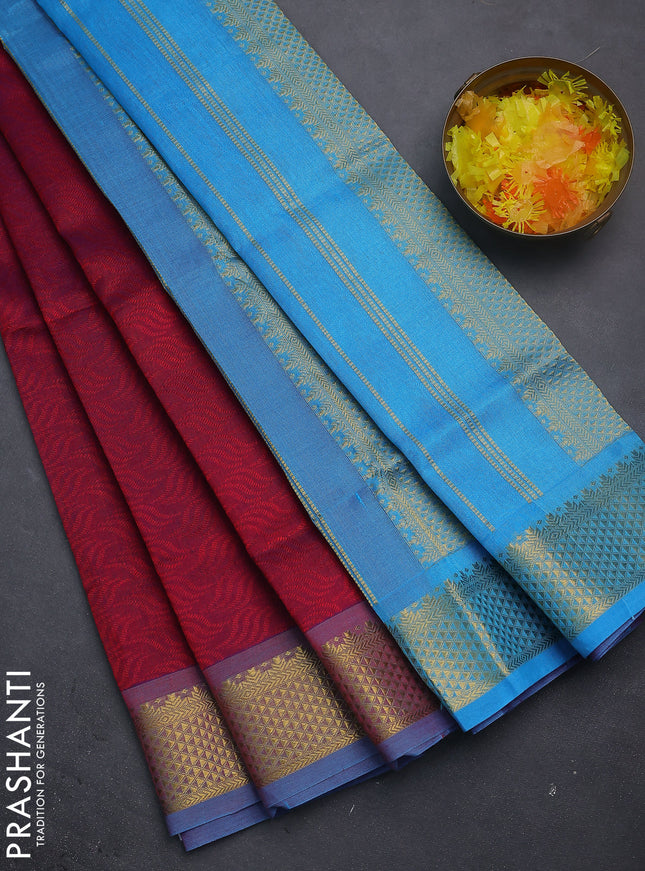 Silk cotton saree dual shade of maroon and blue with allover self emboss jacquard and zari woven border