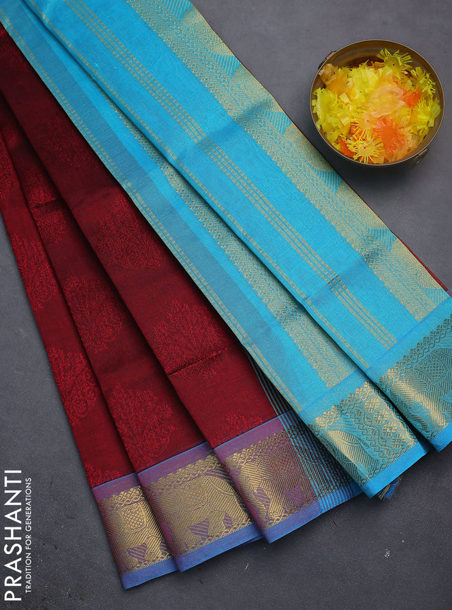 Silk cotton saree maroon and teal blue with allover self emboss jacquard and elephant zari woven border