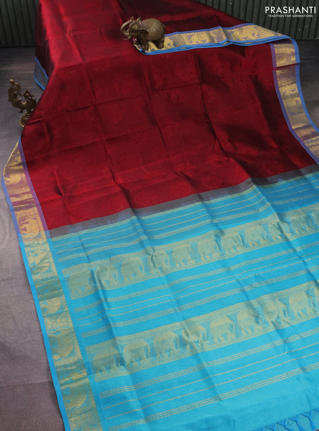 Silk cotton saree maroon and teal blue with allover self emboss jacquard and elephant zari woven border