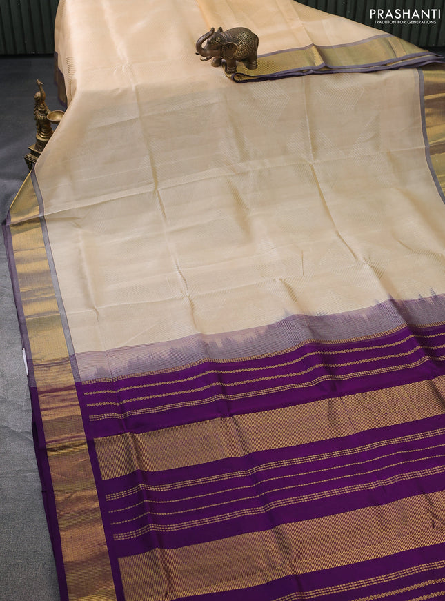 Silk cotton saree sandal and purple with allover self emboss jacquard and zari woven border