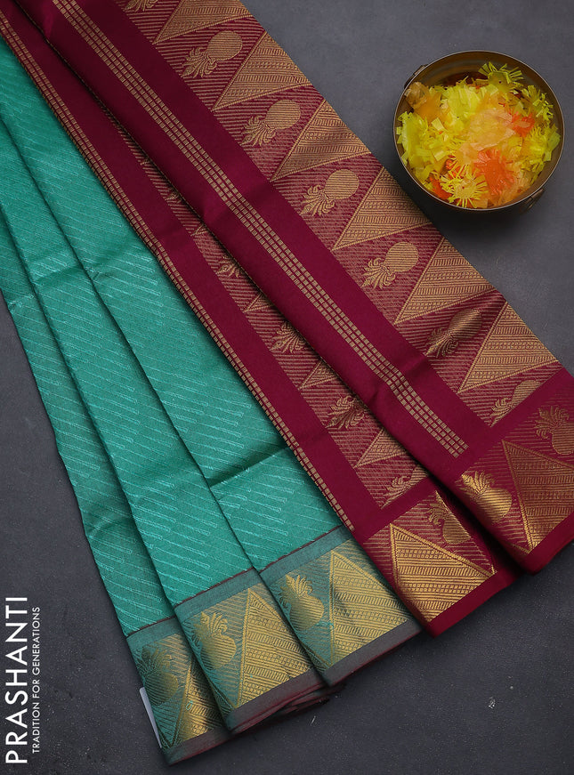 Silk cotton saree teal blue and wine shade with allover self emboss jacquard and zari woven border