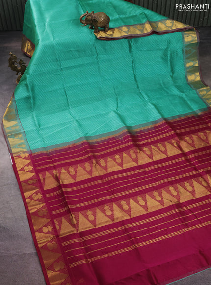 Silk cotton saree teal blue and wine shade with allover self emboss jacquard and zari woven border