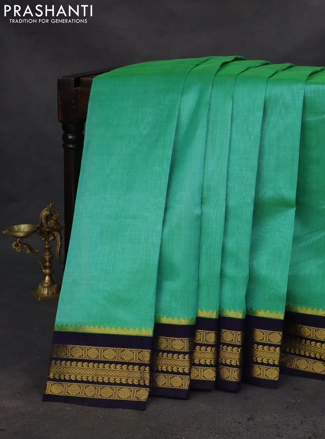 Kuppadam silk cotton saree teal green and navy blue with plain body and zari woven border