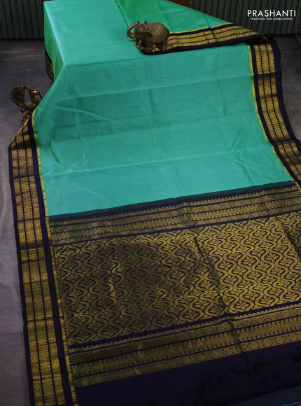 Kuppadam silk cotton saree teal green and navy blue with plain body and zari woven border