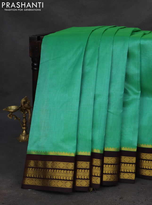 Kuppadam silk cotton saree teal green and deep coffee brown with plain body and zari woven border