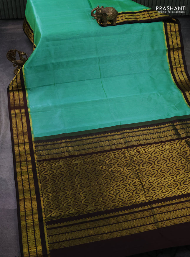 Kuppadam silk cotton saree teal green and deep coffee brown with plain body and zari woven border