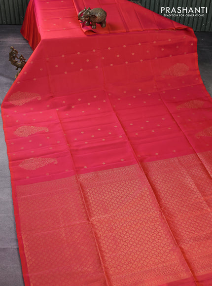 Kanchipuram soft silk saree dual shade of pinkish orange with zari woven buttas and long zari woven paisley butta border