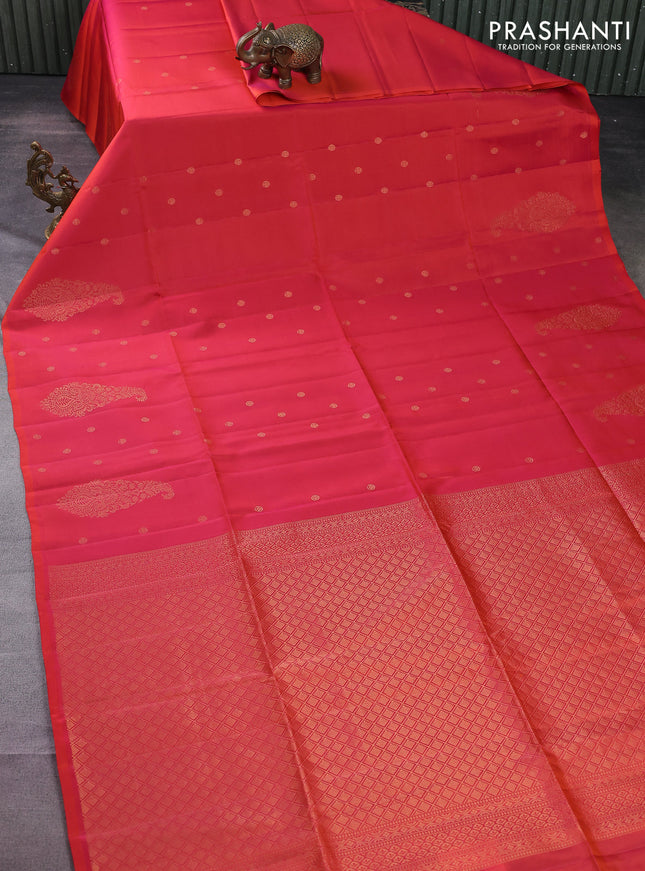 Kanchipuram soft silk saree dual shade of pinkish orange with zari woven buttas and long zari woven paisley butta border