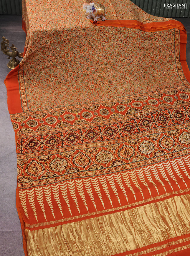 Modal silk saree orange with allover ajrakh prints and simple border