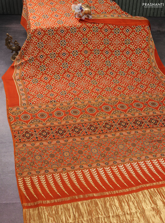 Modal silk saree orange with allover ajrakh prints and printed border