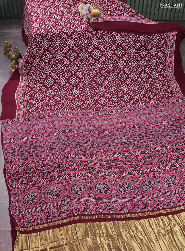 Modal silk saree wine shade with allover ajrakh prints and printed border
