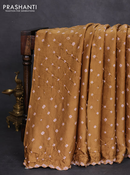 Modal silk saree dark mustard and black with allover bandhini prints and ajrakh printed pallu & blouse