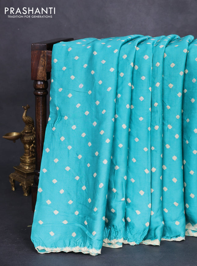 Modal silk saree teal green shade and black with allover bandhini prints and ajrakh printed pallu & blouse