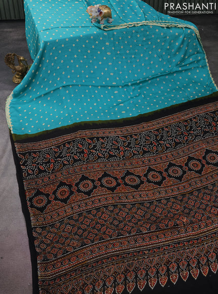 Modal silk saree teal green shade and black with allover bandhini prints and ajrakh printed pallu & blouse