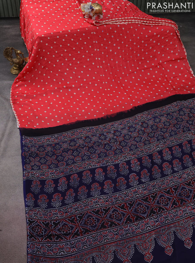 Modal silk saree peach shade and navy blue with allover bandhini prints and ajrakh printed pallu & blouse