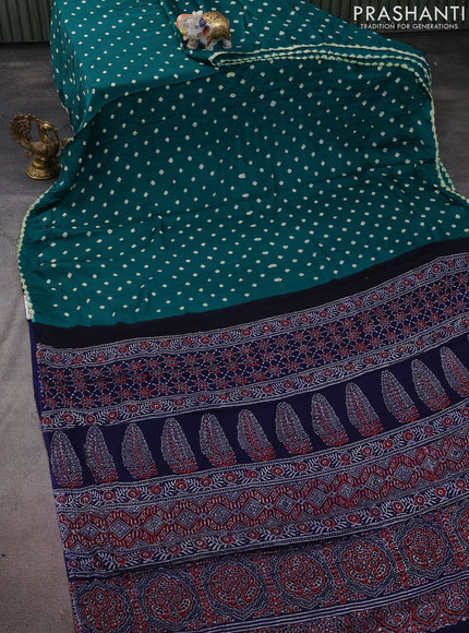 Modal silk saree green and black with allover bandhini prints and ajrakh printed pallu & blouse