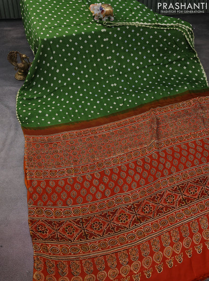 Modal silk saree mehendi green and orange with allover bandhini prints and ajrakh printed pallu & blouse