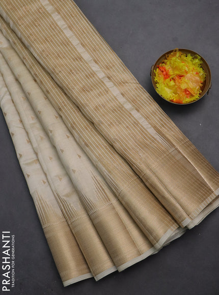 Semi raw silk saree cream with allover zari woven 1000 buttas and temple design zari woven border