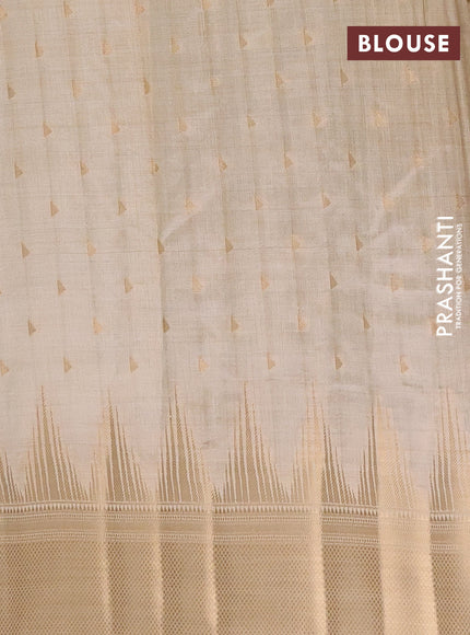 Semi raw silk saree cream with allover zari woven 1000 buttas and temple design zari woven border