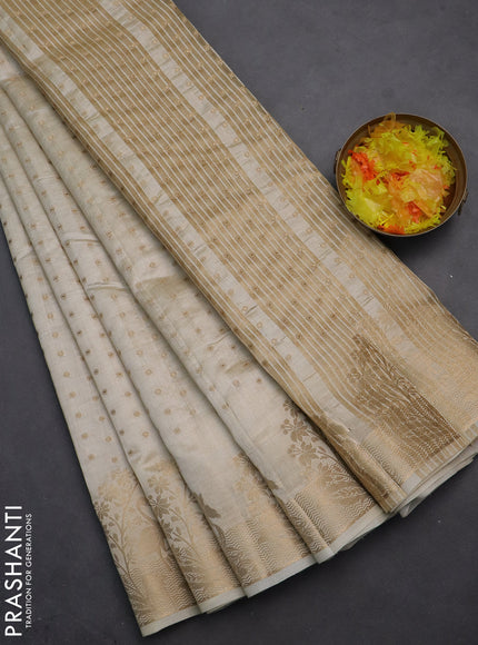 Semi raw silk saree cream with allover zari woven 1000 buttas and rich zari woven border