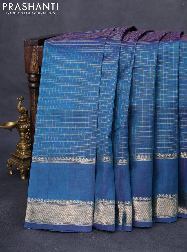 Pure kanchipuram silk saree dual shade of peacock blue with allover zari woven checked pattern and rettapet zari woven butta border