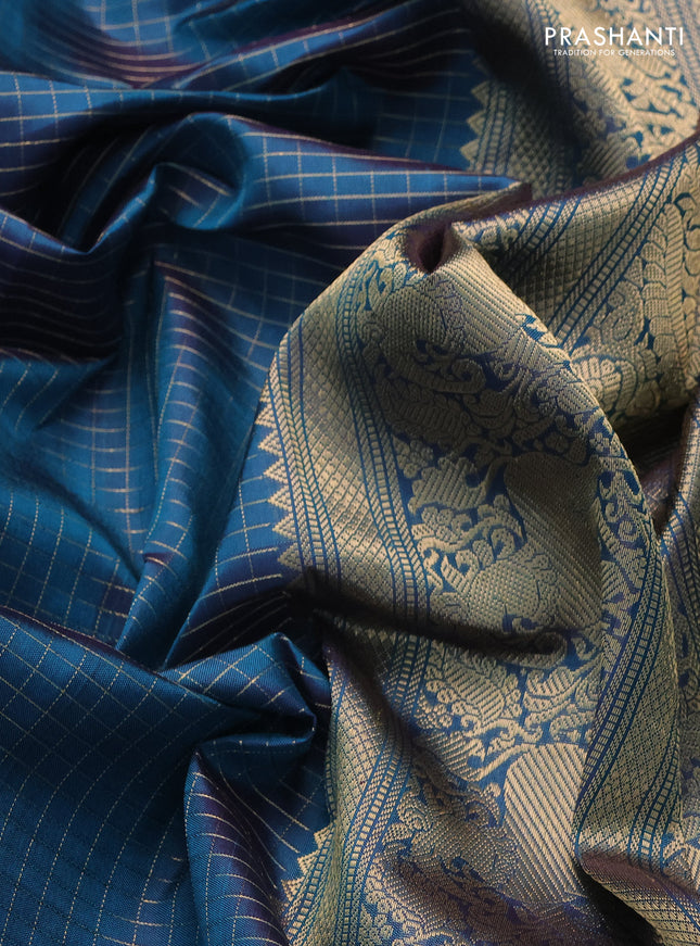 Pure kanchipuram silk saree dual shade of peacock blue with allover zari woven checked pattern and rettapet zari woven butta border