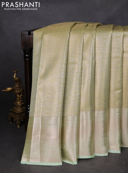 Semi kanchipuram tissue silk saree pista green with allover silver zari woven brocade weaves and long zari woven border