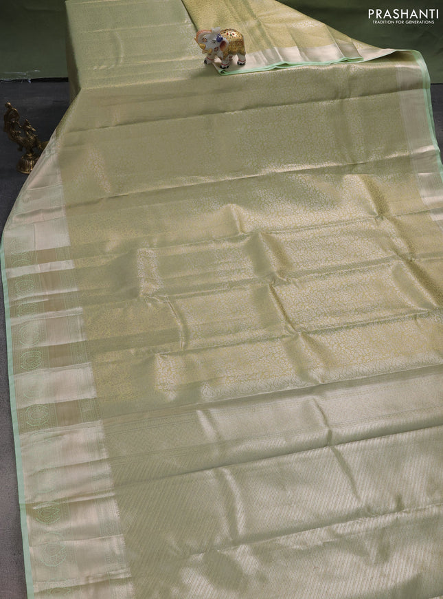 Semi kanchipuram tissue silk saree pista green with allover silver zari woven brocade weaves and long zari woven border