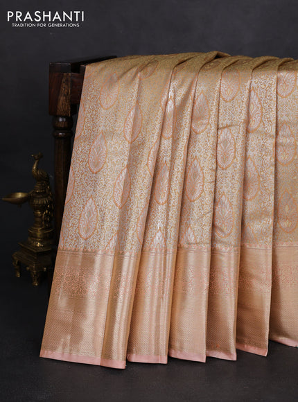 Semi kanchipuram tissue silk saree sandal and pastel peach with allover silver zari woven brocade weaves and long zari woven border