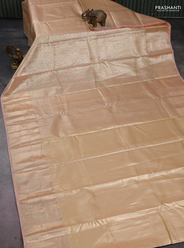 Semi kanchipuram tissue silk saree sandal and pastel peach with allover silver zari woven brocade weaves and long zari woven border
